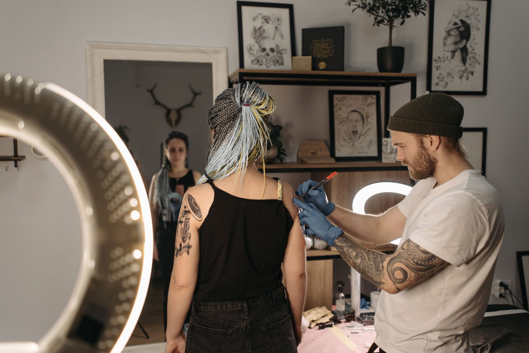 Tattoo artist at work with a client in the studio
